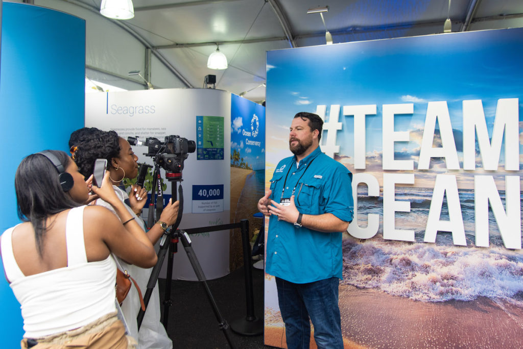 JP Brooker speaks to journalists in the Ocean Conservancy booth at Super Bowl LIV in Miami